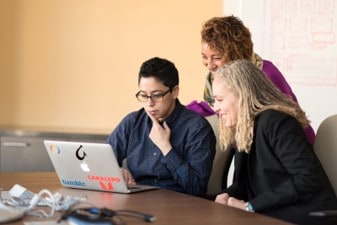 Persons looking at a computer