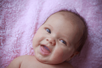 A smiling baby. Genetic counseling can help diagnose infants and children at any age. 