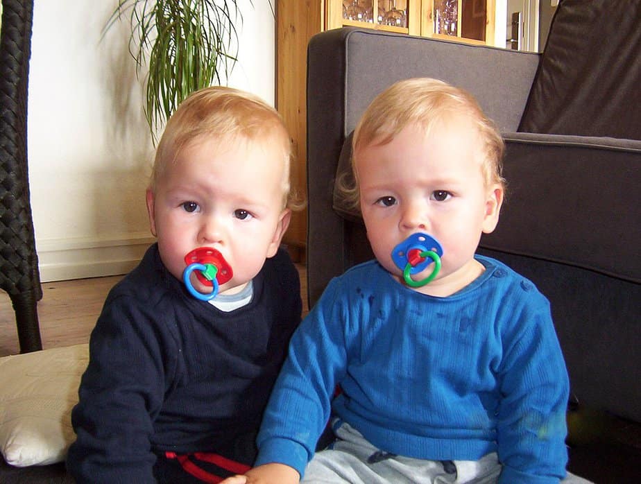 Twin toddlers with pacifiers